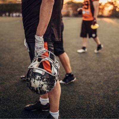 Football player with helmet in hand