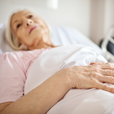 older woman laying in bed