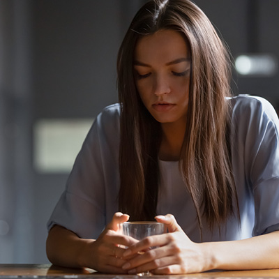 woman looking at a glass