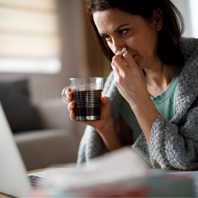 Woman blowing nose