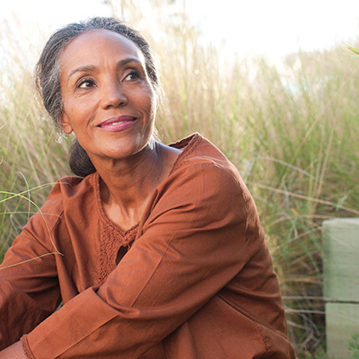 Woman with grass behind her