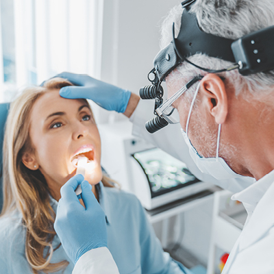 Doctor looking at womans tonsils