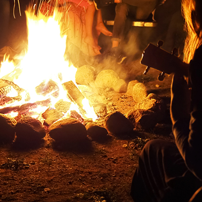 People sitting safely around a fire 