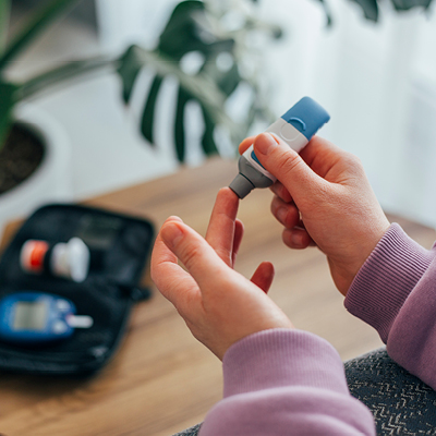 person testing their blood sugar