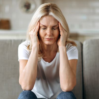 Woman holding her hands on her head
