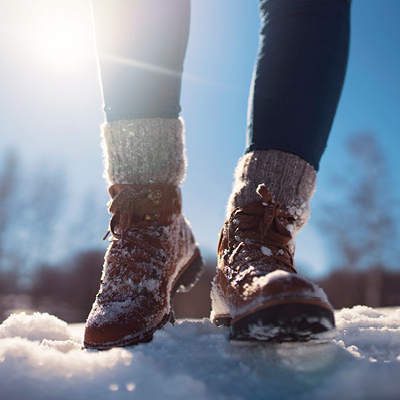 Person walking in snow with boots