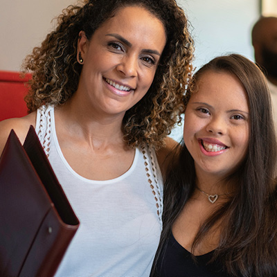 two women with arms around each others shoulders
