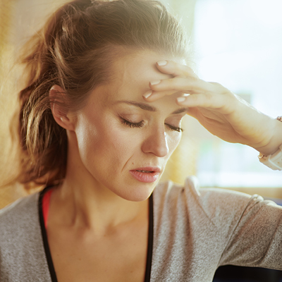 Person holding their head in discomfort