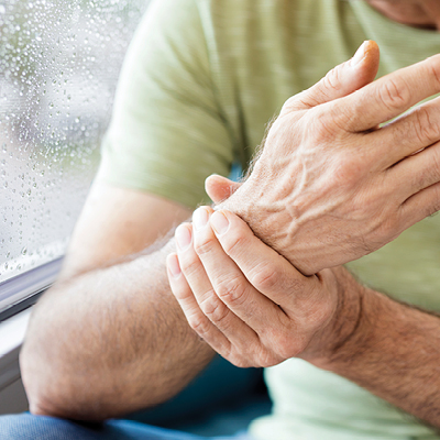 man holding his wrist in pain