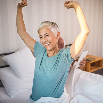 woman stretching in bed