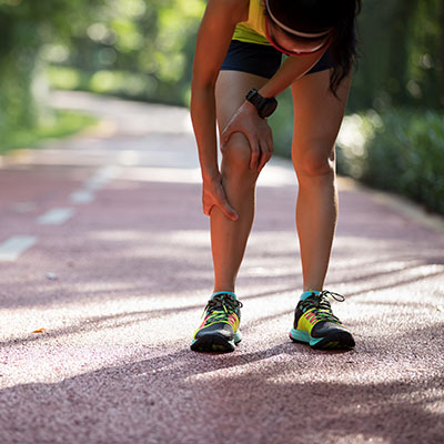Shin splints Woman holding shin in pain