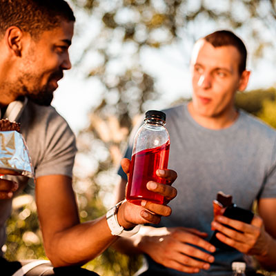 gel, energy, or carbs Two guys eating snacks after running