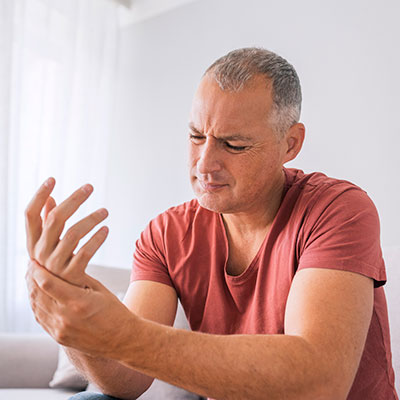 Man holding hand in pain