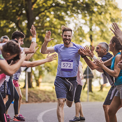 Your first organized race Man being cheered on by other runners