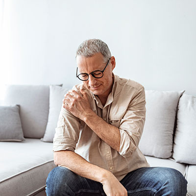 shoulder-arm-injury Older gentleman holding his shoulder in pain
