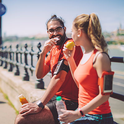 Man and women stopped to eat food during run