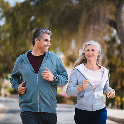 Starting a routine Older man and women running on the street