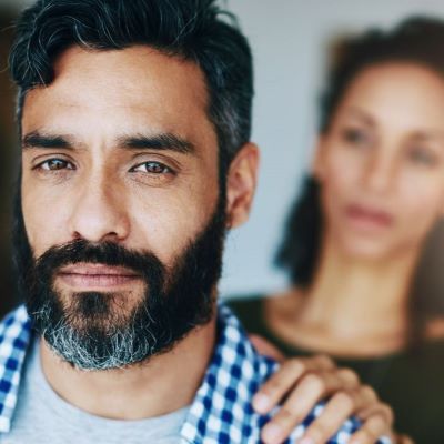 Person with a hand on someone's shoulder