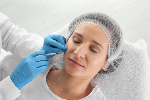 A patient receiving a botox injection in their face