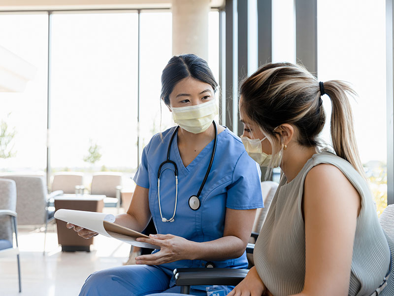 Immunotherapy treatment patient speaking with a nurse