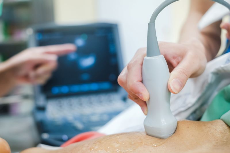 Tech using wand for ultrasound