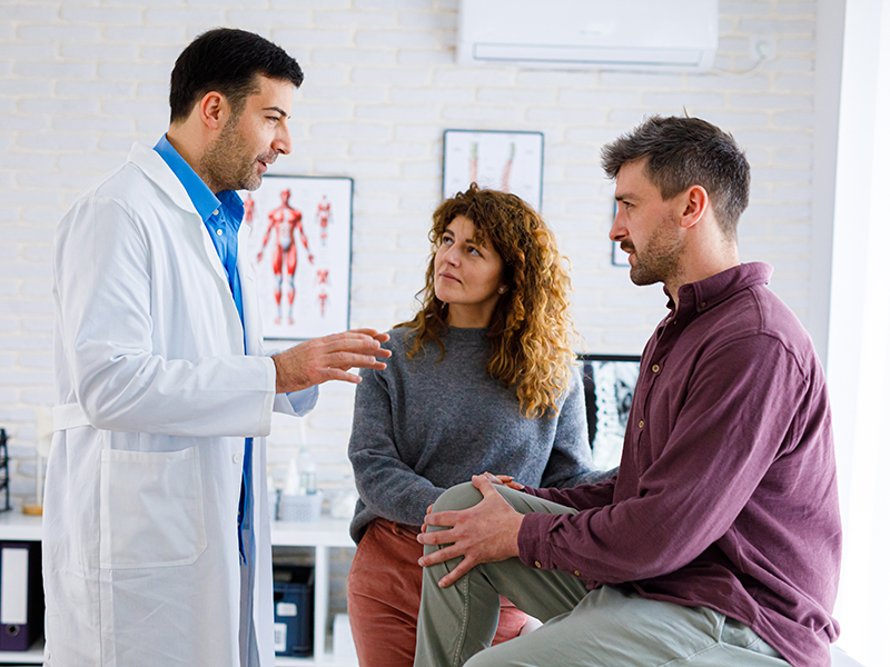 Sports Medicine doctor with male patient and female 