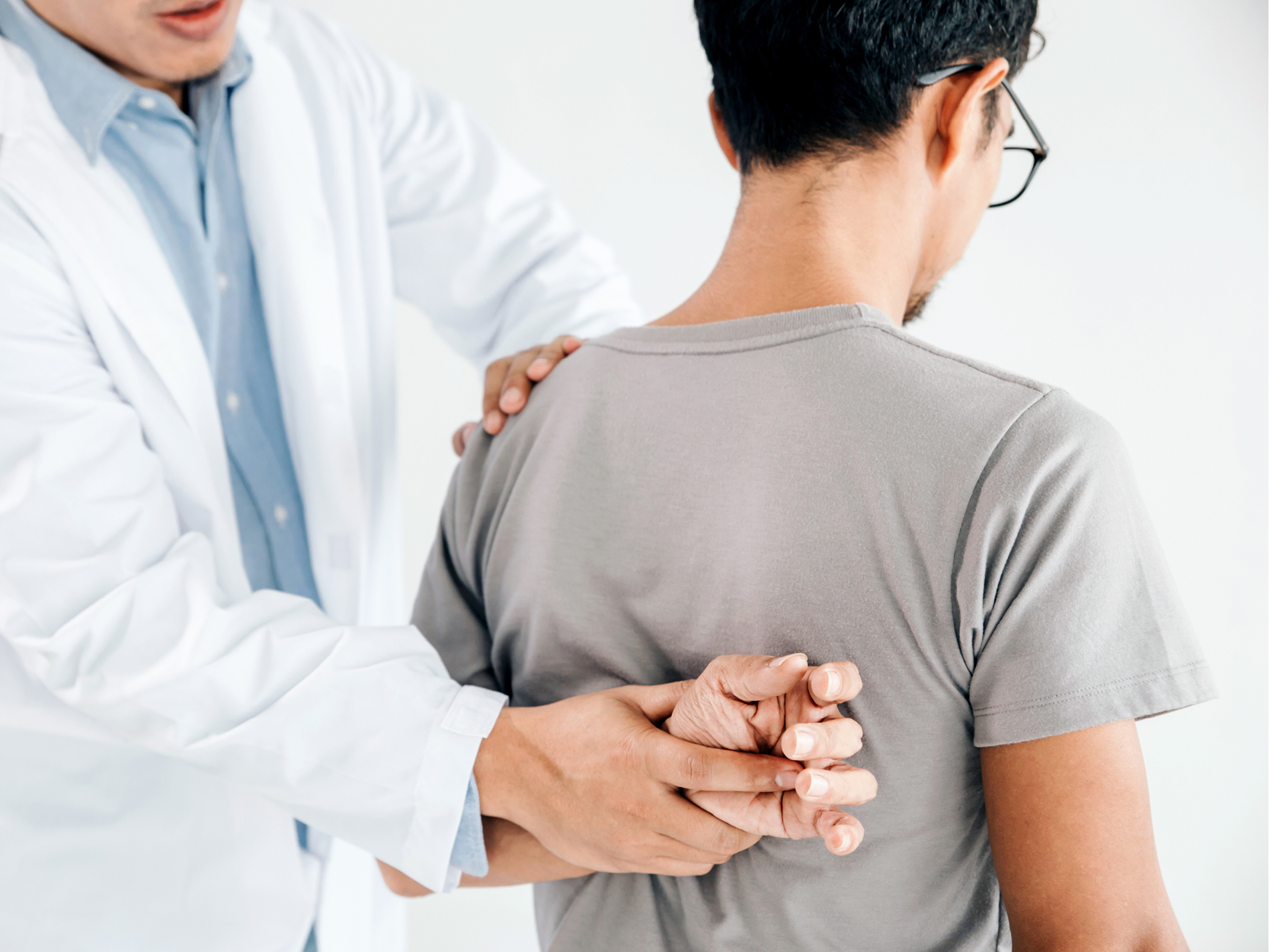 Doctor doing healing treatment on man's back
