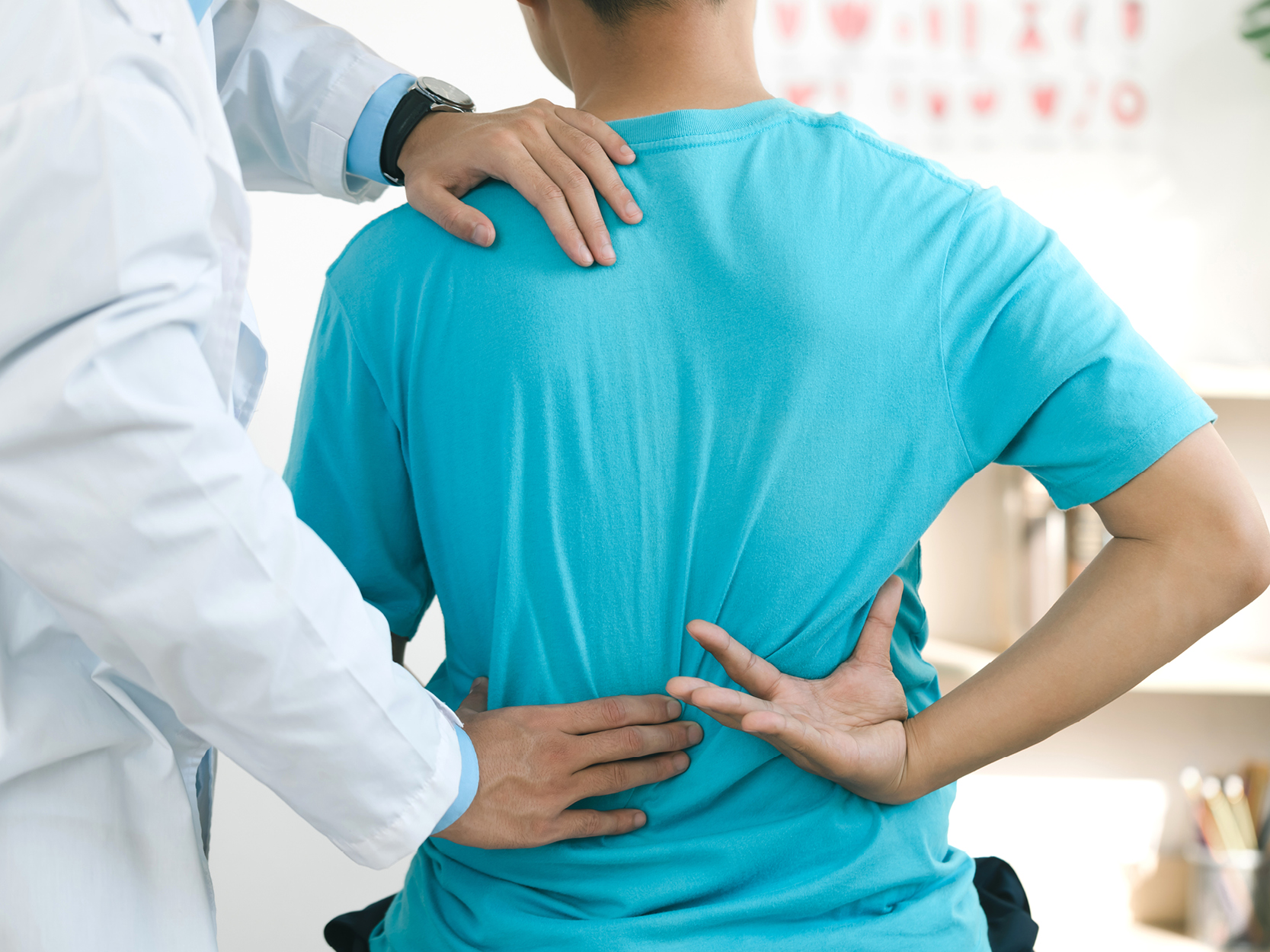 Doctor treats lower back pain in patients in the hospital with back injuries and back massages