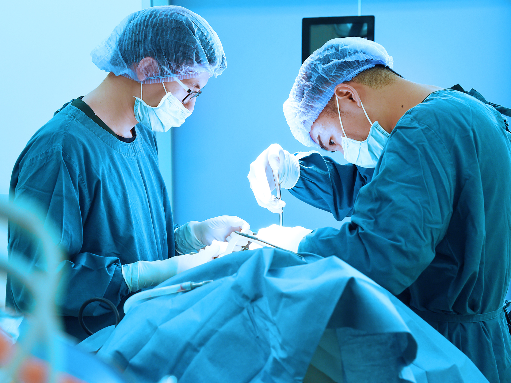 Team work of doctor or surgeon doing surgery using an orthopedic wrench