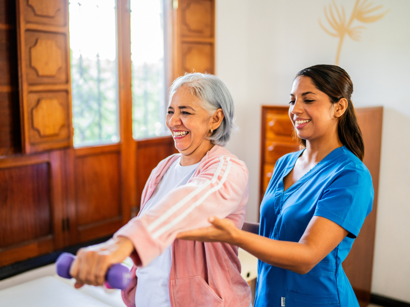 Nurse assisting patient with rehabilitation exercises.