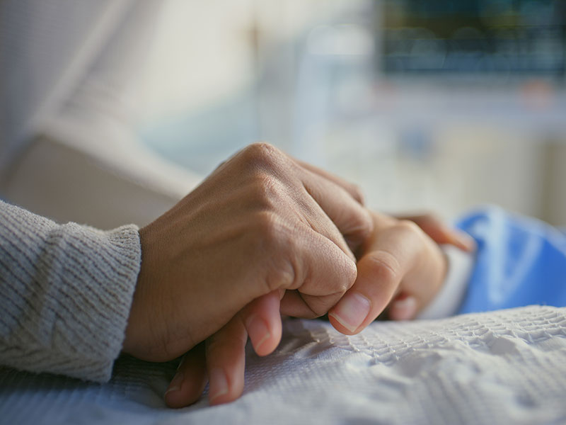 Doctor holding patients hand