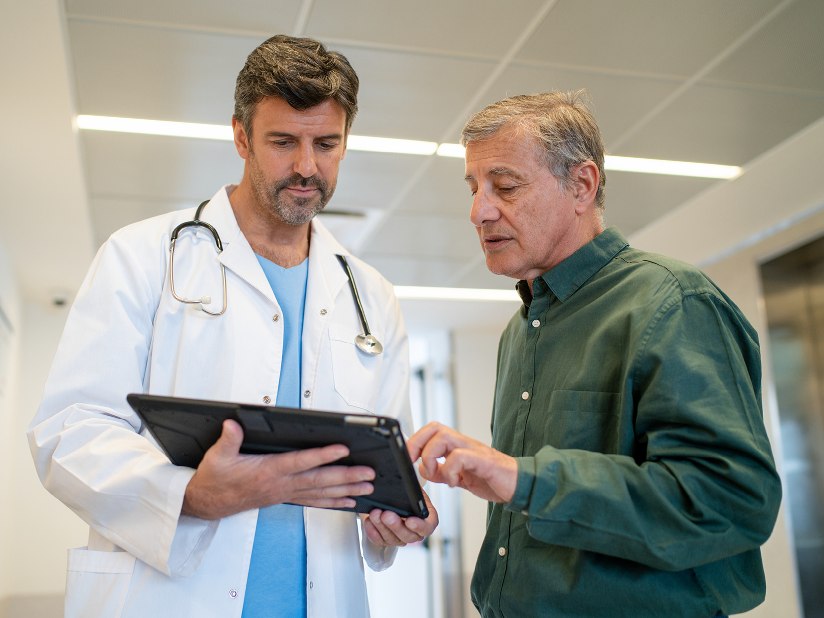 Englarged Prostate CTA - Doctor and male patient looking at charts