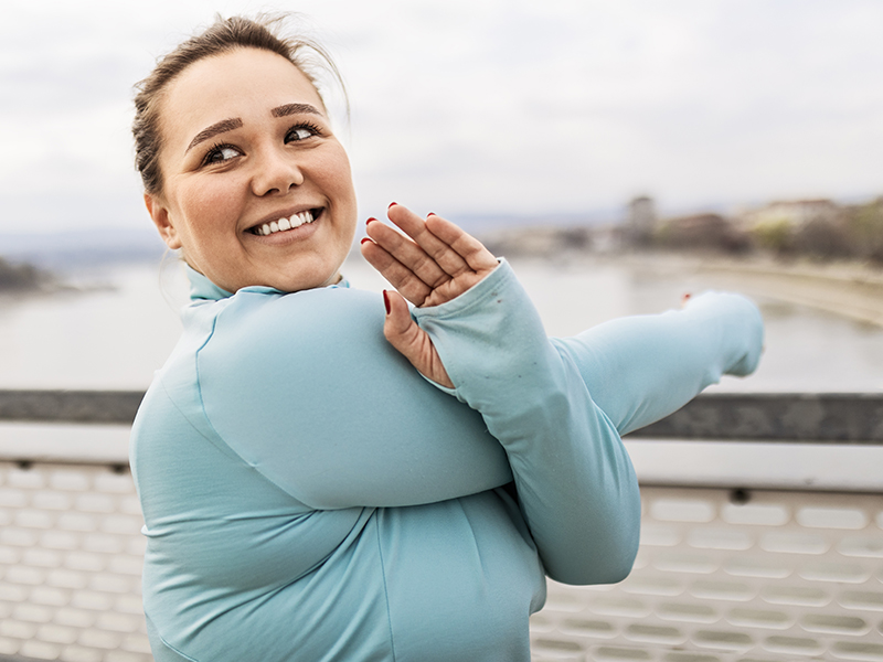woman stretching and smiling