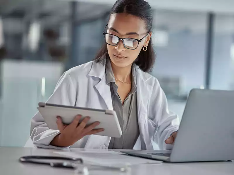 Female doctor at computer doing a referral